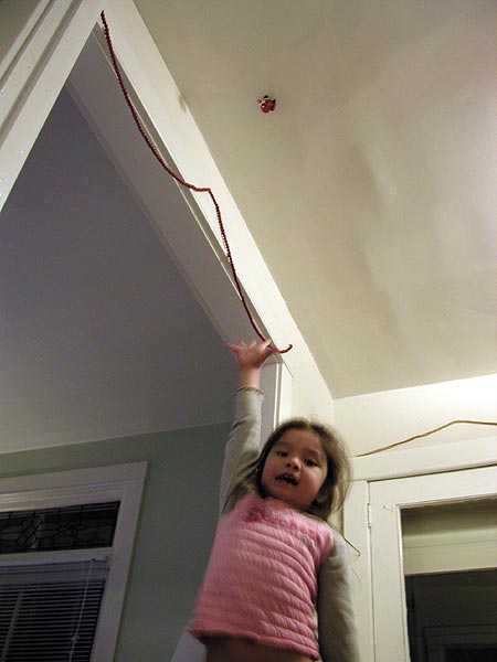 reaching for the santa that's stuck to the ceiling