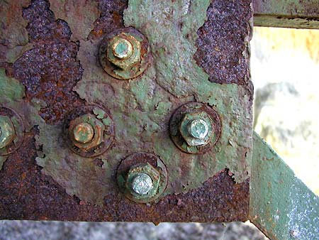 closeup of rusty green bolts