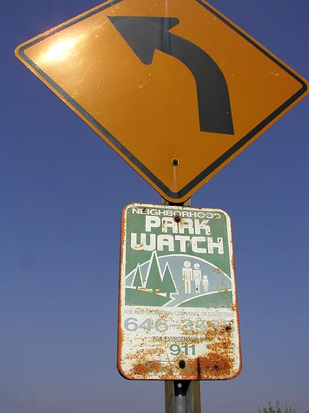 rusting neighborhood park watch signage