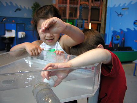 the kids, struggling over a ping pong ball