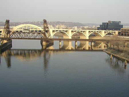 reflection of the robert street bridge in/over the mississippi