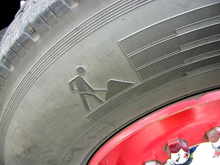 strange little man symbol on firetruck tire